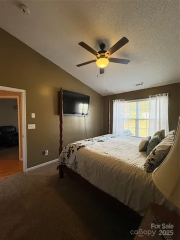 a bedroom with a large bed and a window