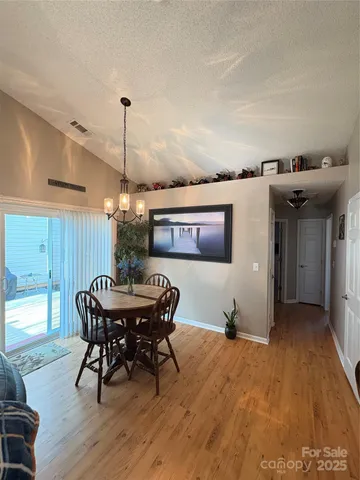 a view of a dining room with furniture and chandelier