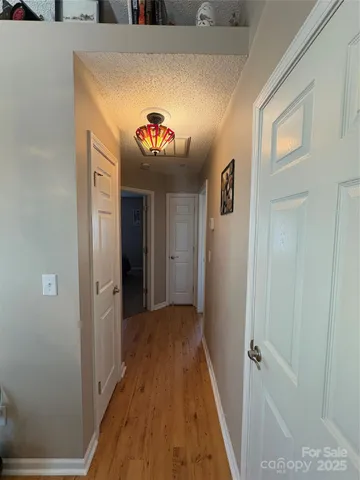 a view of a hallway with paintings on the wall