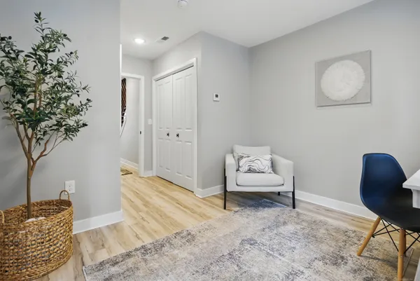 a bedroom with furniture and a potted plant