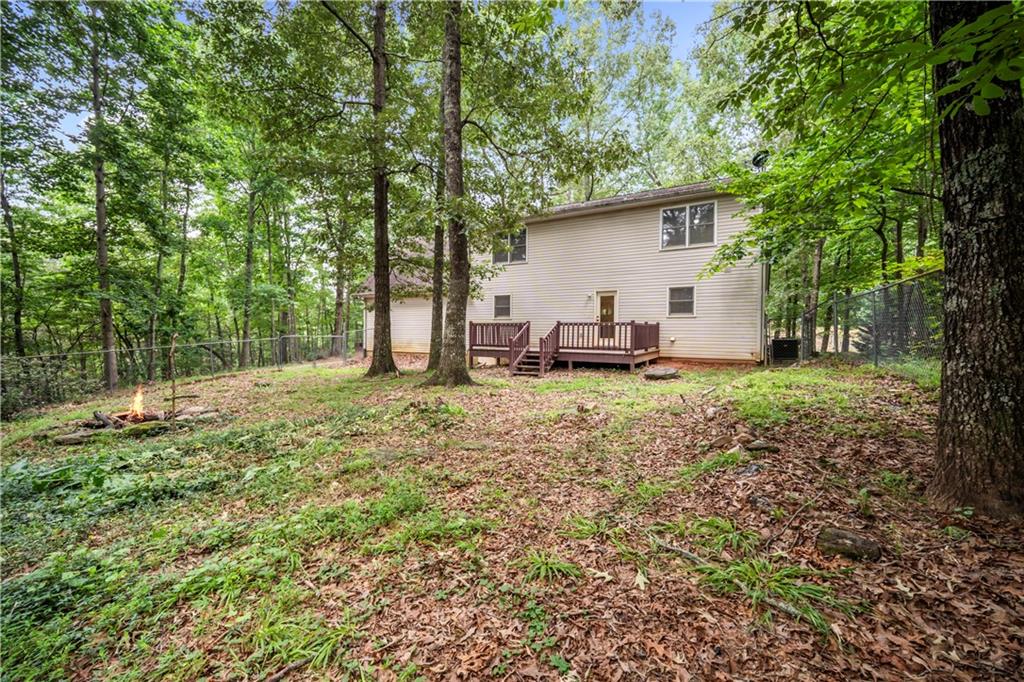 2009 Ben Higgins Road Dahlonega, GA 30533 - Photo 22 of 25 a backyard of a house with table and chairs