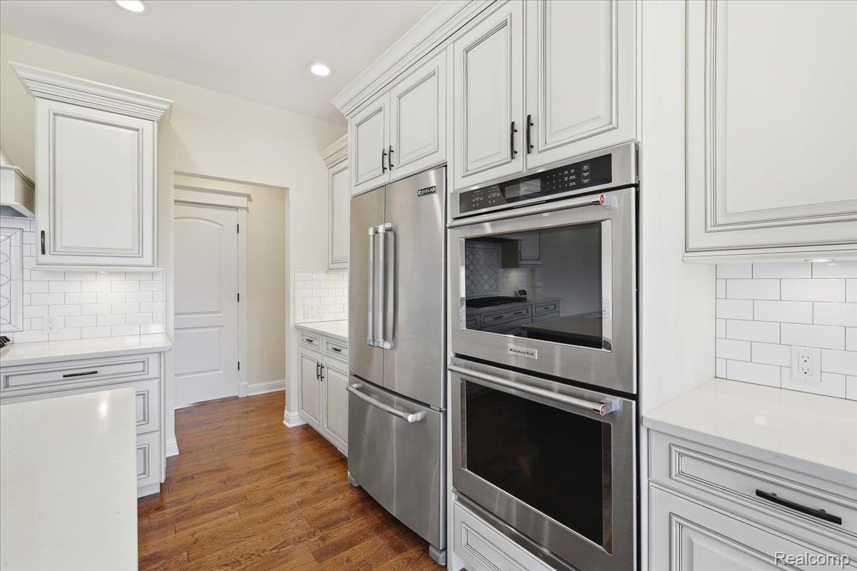 35339 West 13 Mile Road Farmington, MI 48331 - Photo 11 of 72 Kitchen featuring stainless steel appliances, tasteful backsplash, white cabinets, light stone counters, and recessed lighting