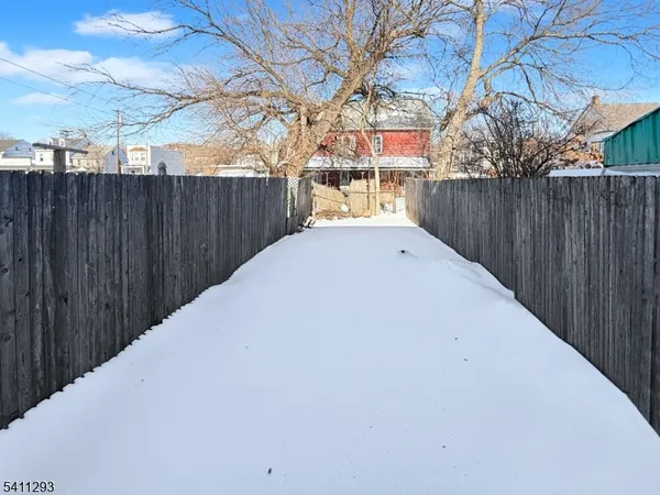 a view of a backyard with wooden fence