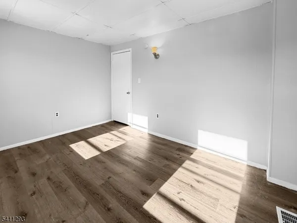 an empty room with wooden floor