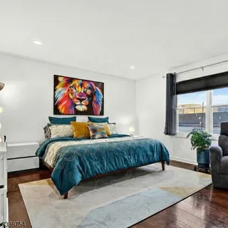 a living room with a bed furniture and a potted plant