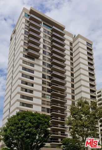 a lobby with furniture and a chandelier