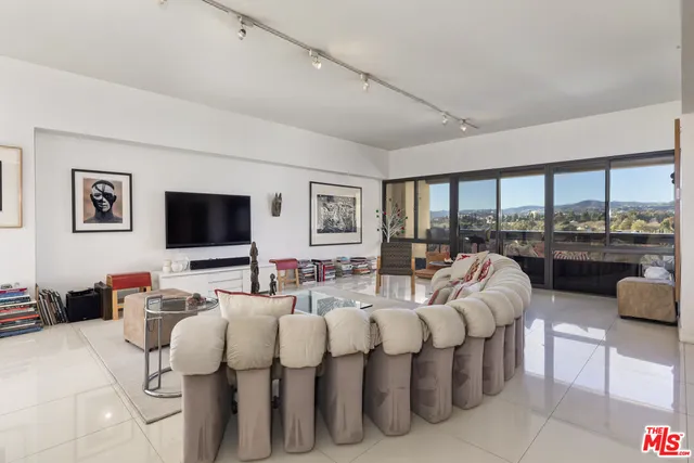 a balcony with table and chairs