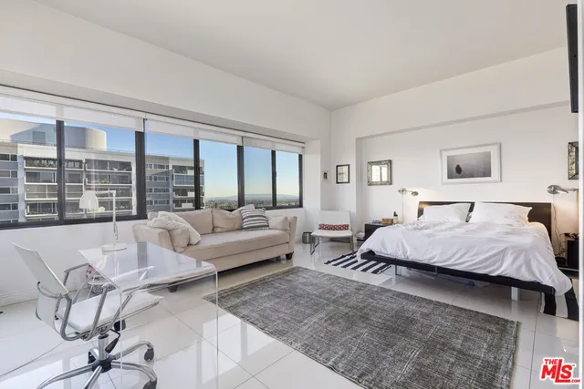 a bathroom with a granite countertop sink a toilet and bathtub