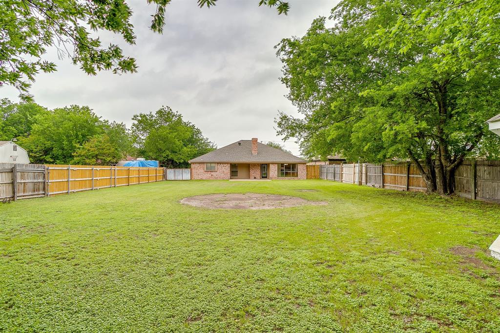 8613 Silver Creek Road White Settlement, TX 76108 - Photo 33 of 40 a front view of a house with a garden