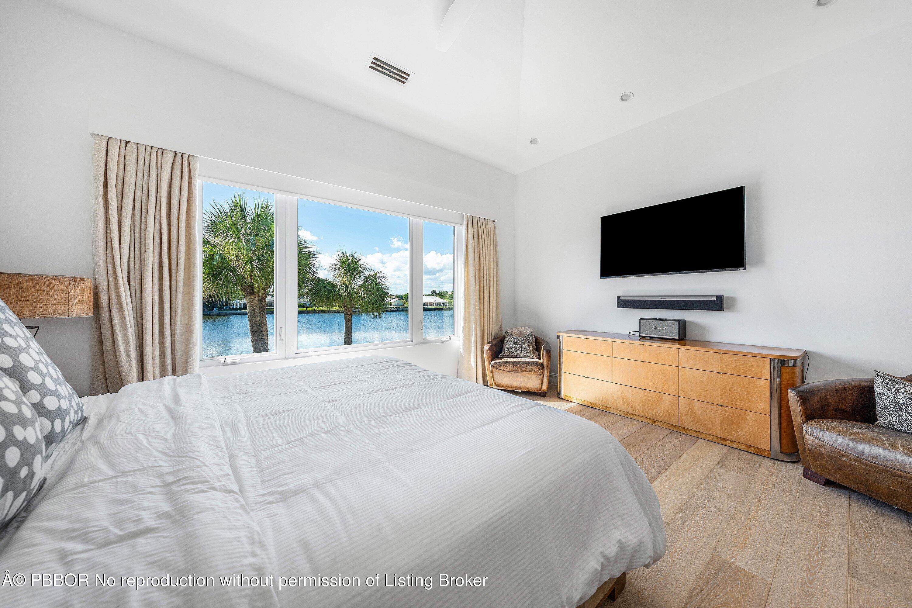 50 Spoonbill Road Lantana, FL 33462 - Photo 26 of 37 a bedroom with a bed and a flat screen tv