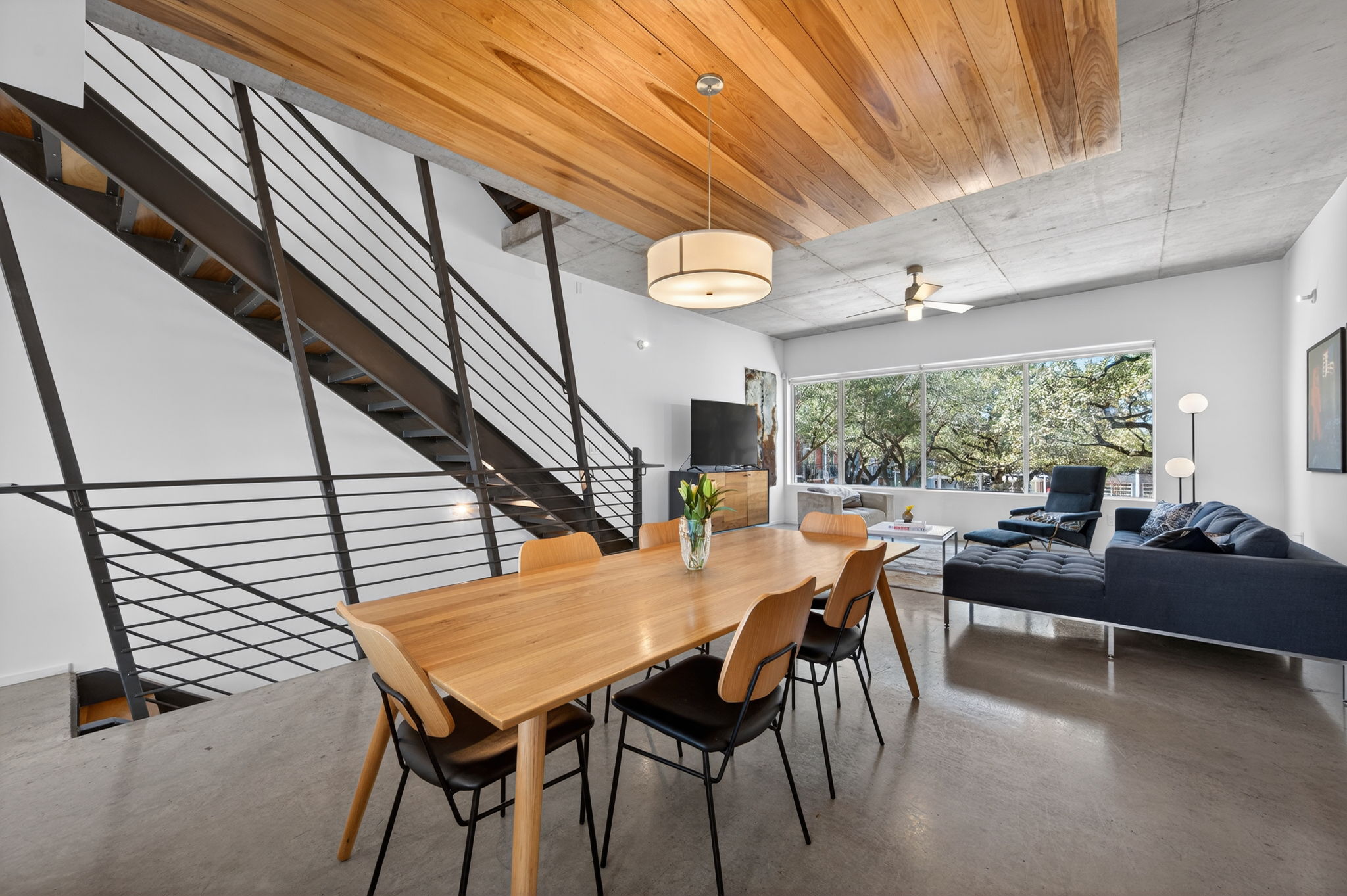 2301 South 5th Street, Unit 25 Austin, TX 78704 - Photo 3 of 35 Dining room featuring concrete floors, wood ceiling, and a ceiling fan