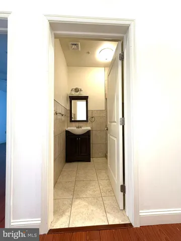 a view of bathroom with mirror toilet and a shower