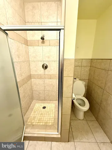 a bathroom with a toilet and a shower