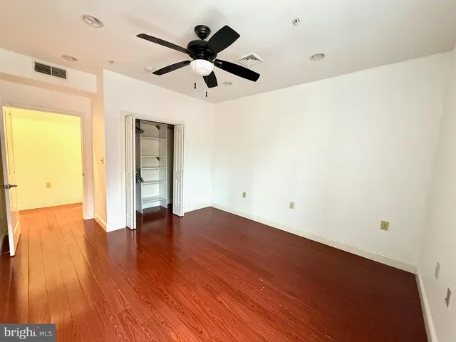 a view of empty room with wooden floor