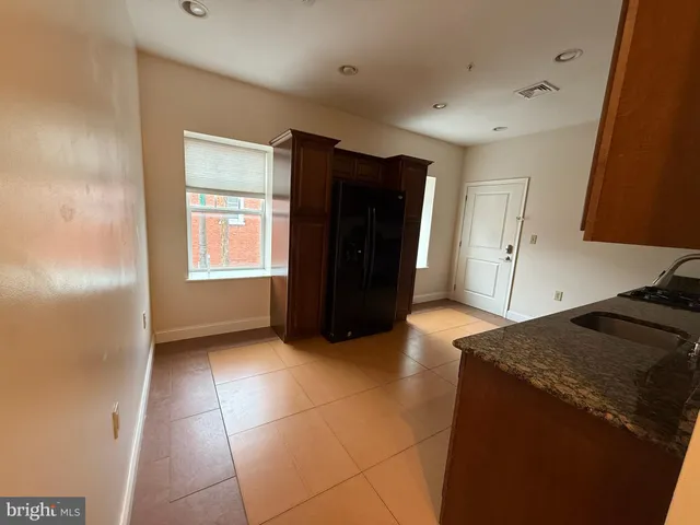 a kitchen with a refrigerator and window