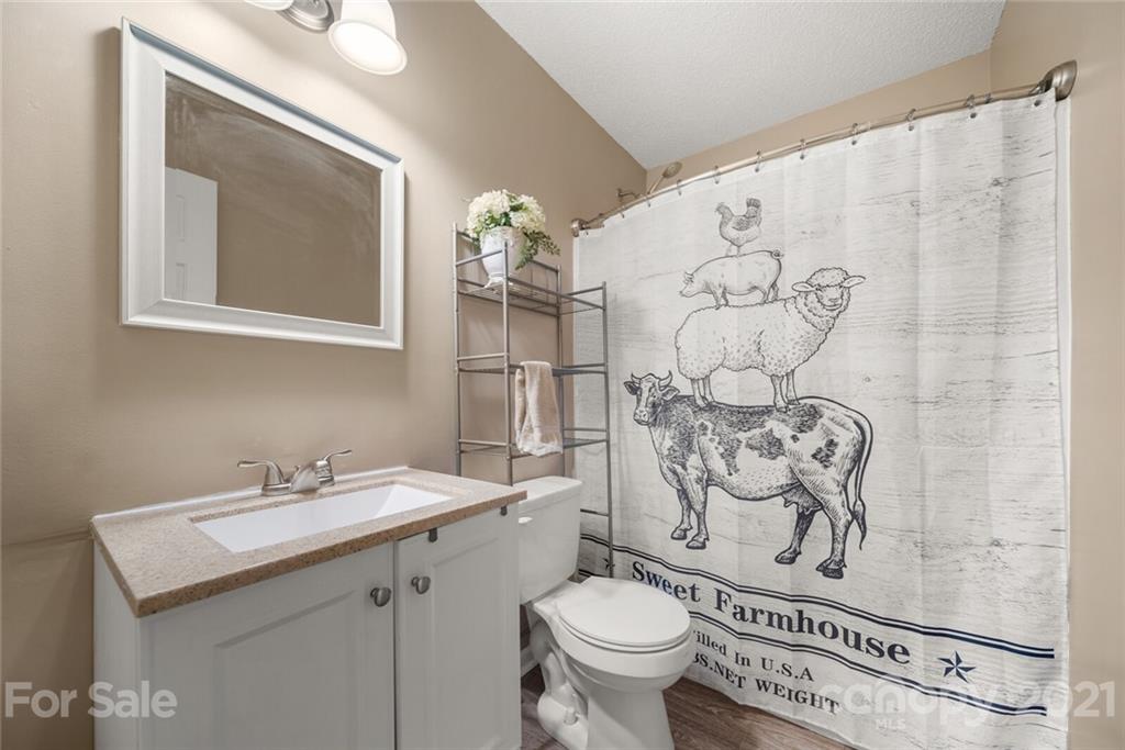 3614 White Store Road, Unit 5 Wingate, NC 28174 - Photo 14 of 21 a bathroom with a toilet sink and mirror