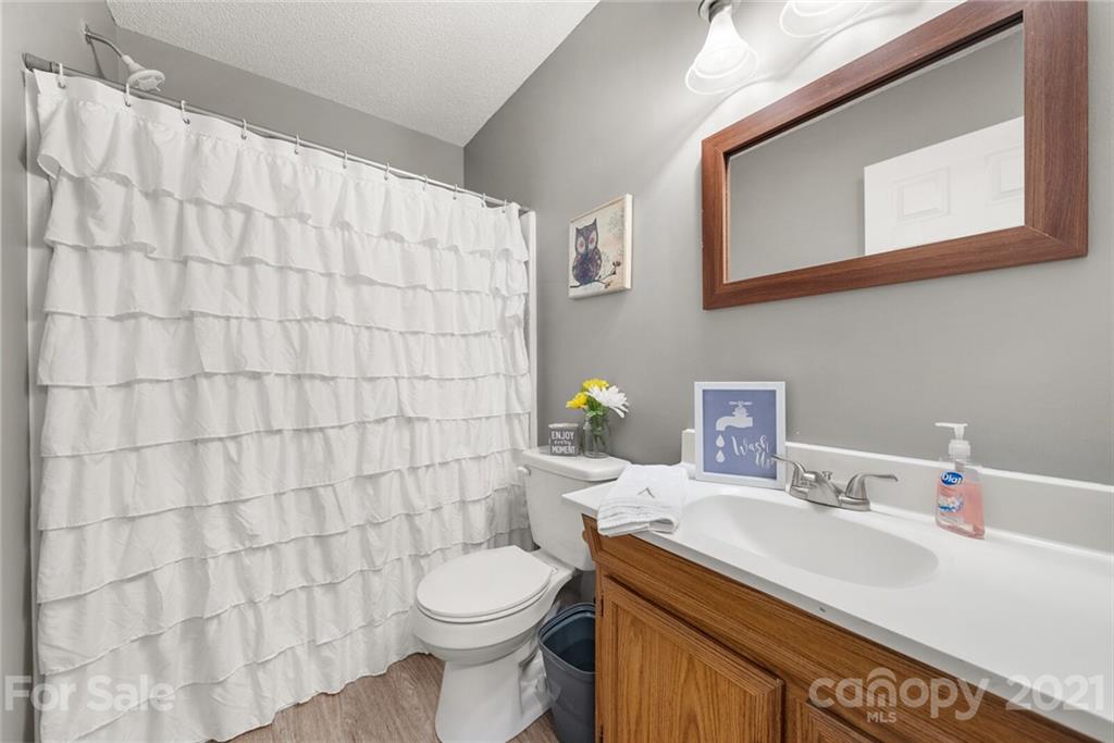 3614 White Store Road, Unit 5 Wingate, NC 28174 - Photo 17 of 21 a bathroom with a sink a toilet and a mirror