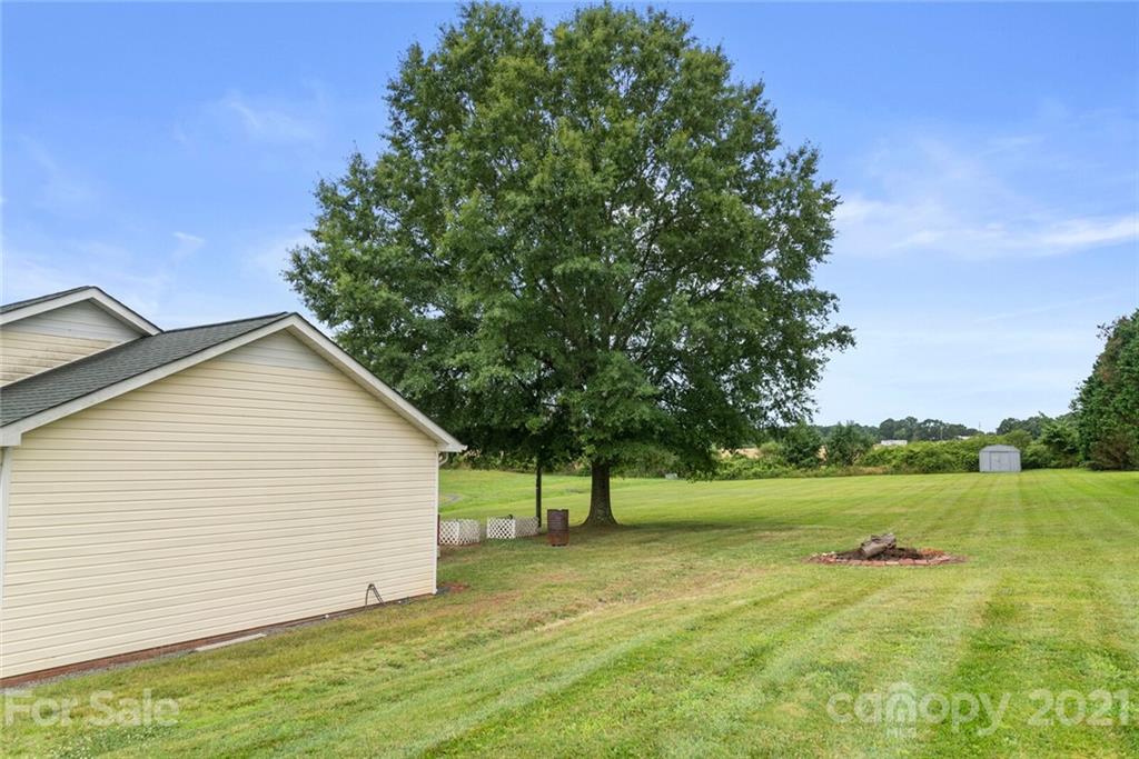 3614 White Store Road, Unit 5 Wingate, NC 28174 - Photo 20 of 21 a view of an house with backyard space and tree