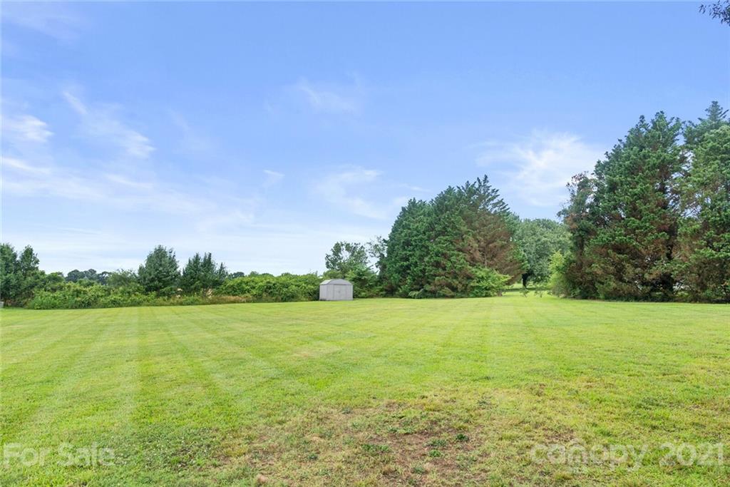 3614 White Store Road, Unit 5 Wingate, NC 28174 - Photo 21 of 21 a view of yard with swimming pool and trees in the background