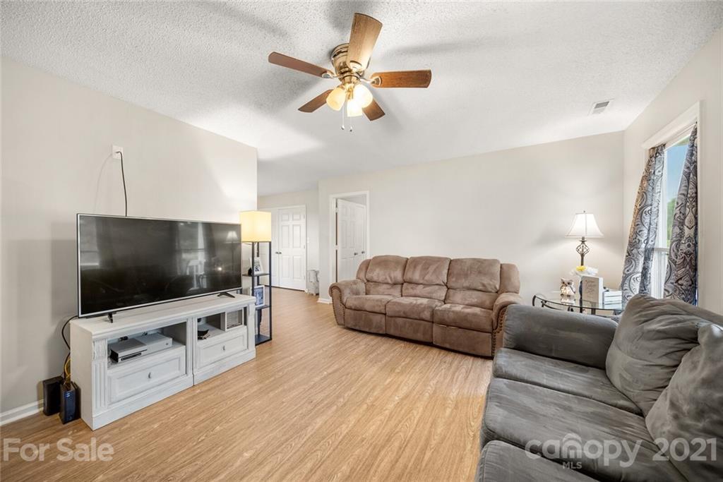 3614 White Store Road, Unit 5 Wingate, NC 28174 - Photo 5 of 21 a living room with furniture and a flat screen tv