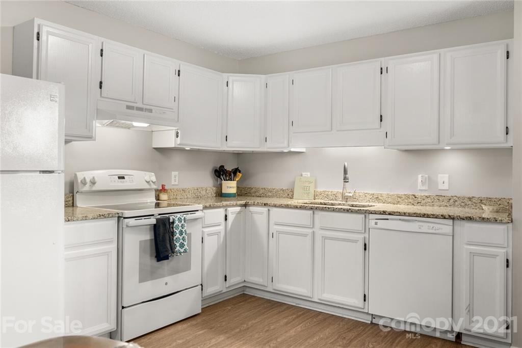 3614 White Store Road, Unit 5 Wingate, NC 28174 - Photo 7 of 21 a kitchen with granite countertop white cabinets and white appliances
