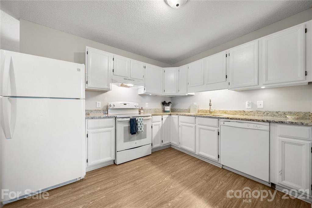 3614 White Store Road, Unit 5 Wingate, NC 28174 - Photo 8 of 21 a kitchen with granite countertop white cabinets and white appliances