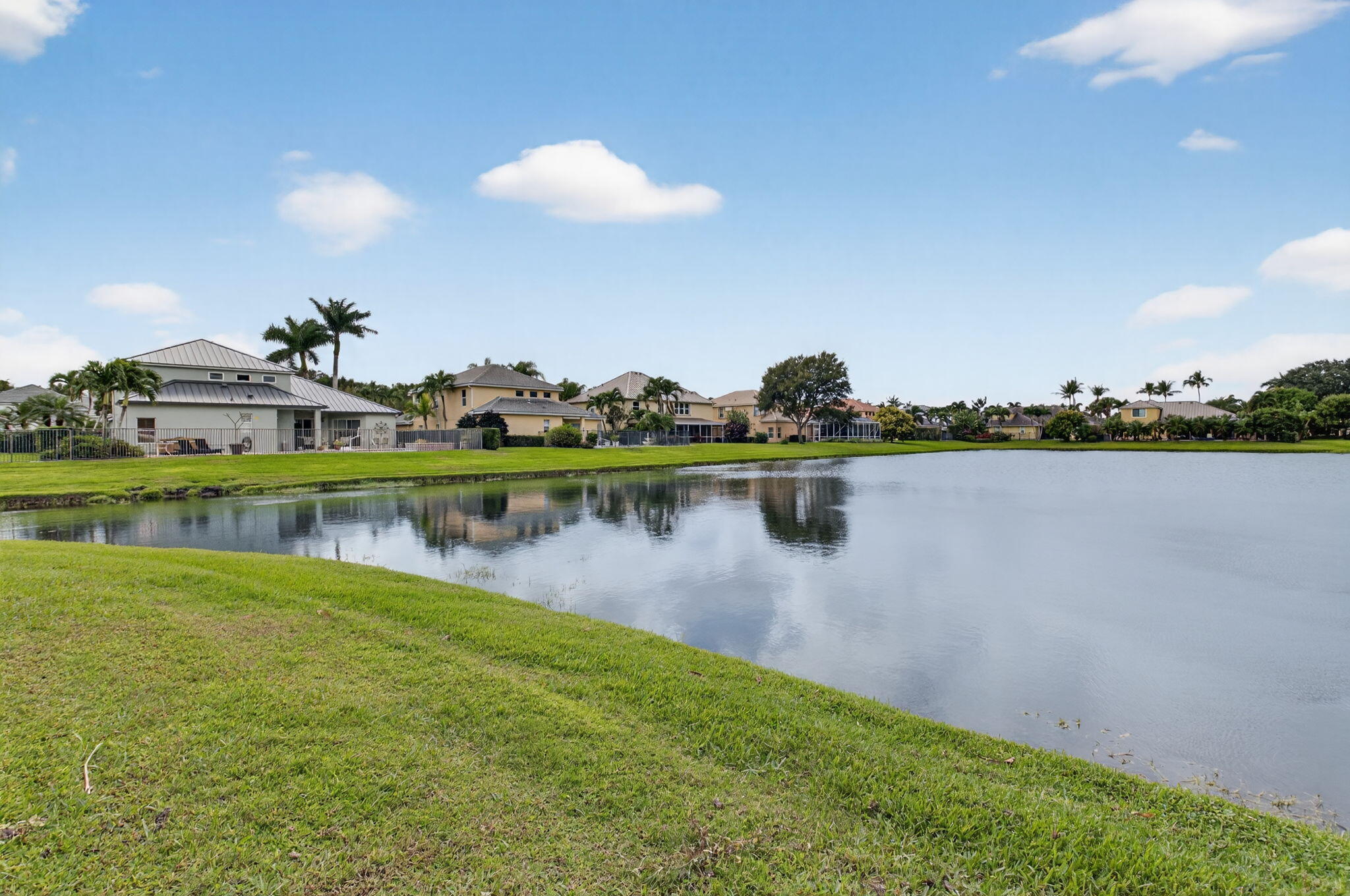 7209 Serrano Terrace Delray Beach, FL 33446 - Photo 43 of 48 a view of a lake with houses in the back