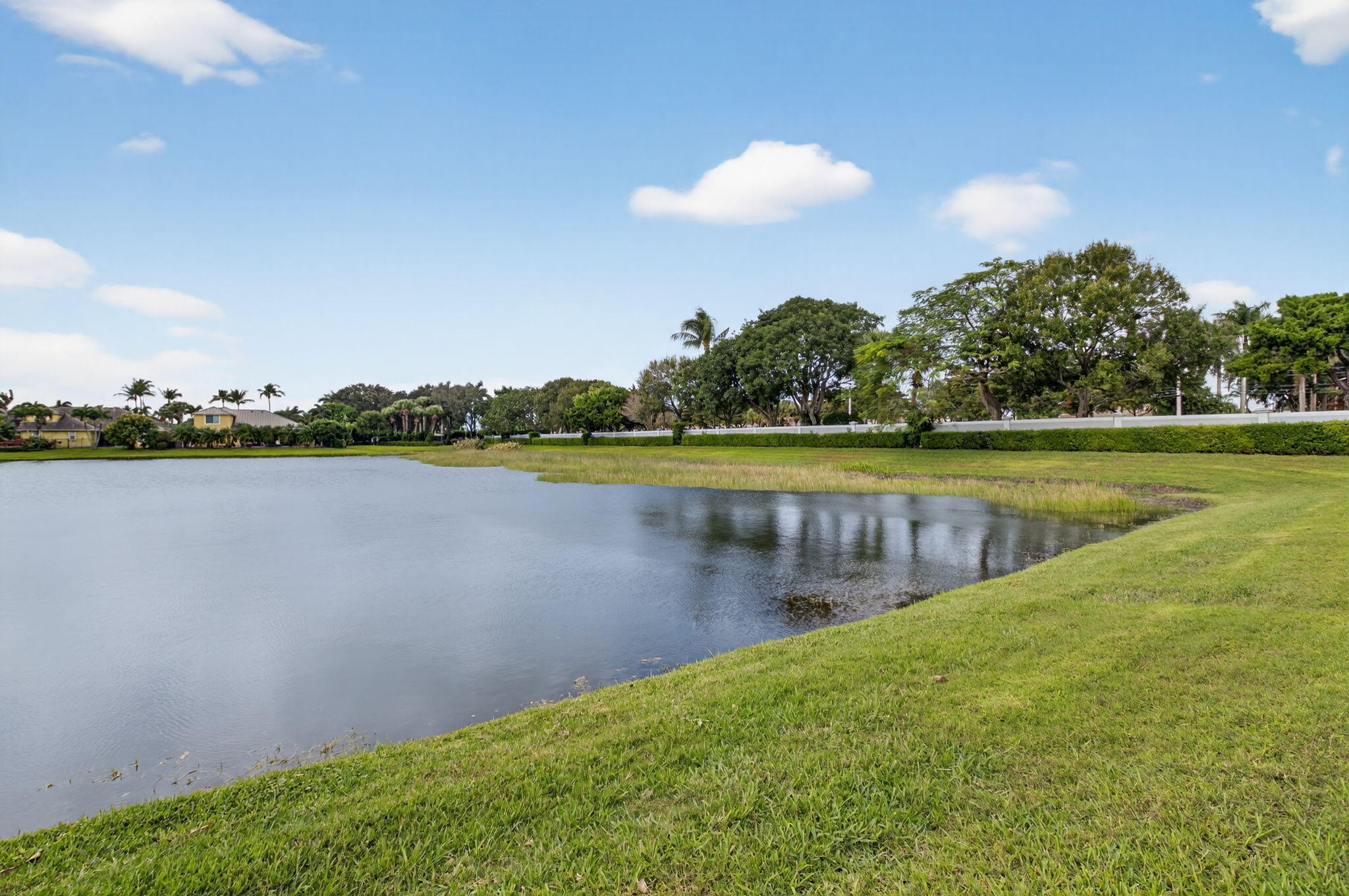 7209 Serrano Terrace Delray Beach, FL 33446 - Photo 44 of 48 a view of a lake with houses in the back