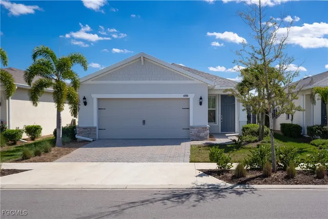 a front view of a house with a yard and a garage
