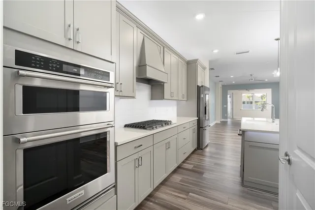 a kitchen with stainless steel appliances white cabinets and a stove