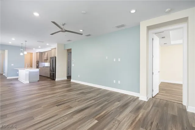 a view of a livingroom with a hall and wooden floor