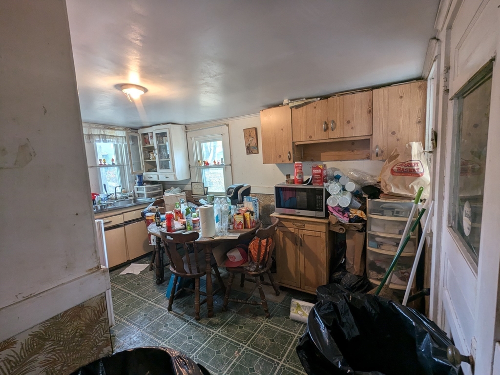 14 Washington Avenue Ashland, MA 01721 - Photo 12 of 23 a kitchen filled with a dining table chairs and a refrigerator