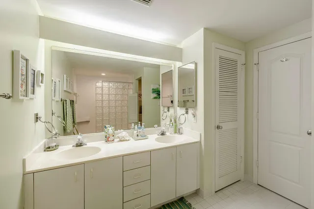 a bathroom with double sink and a mirror