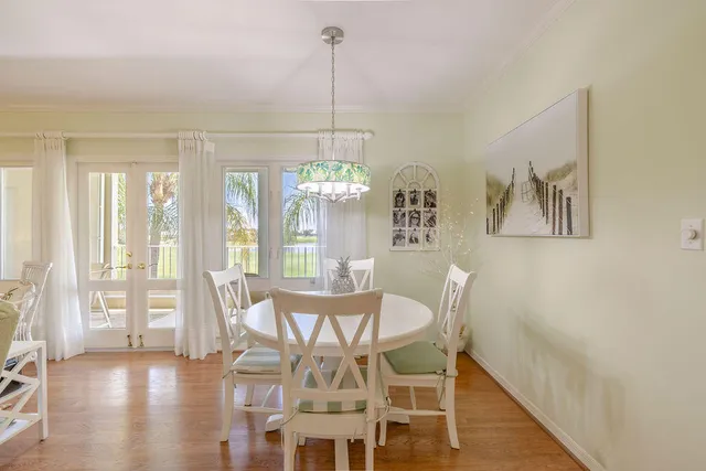 a view of a dining room with furniture wooden floor and chandelier
