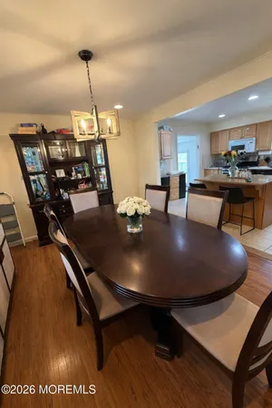 a dining room with furniture and wooden floor