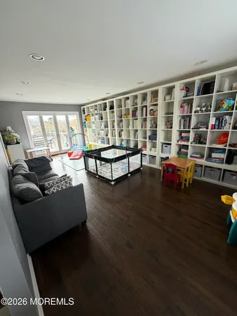 a living room with furniture and a book shelf