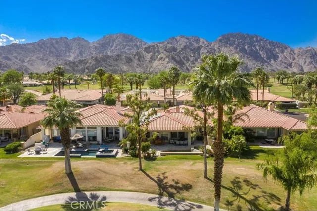 a view of swimming pool with outdoor seating and mountain view