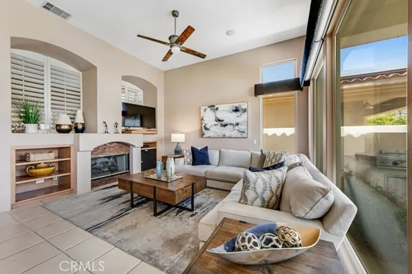 a living room with furniture a fireplace and a flat screen tv