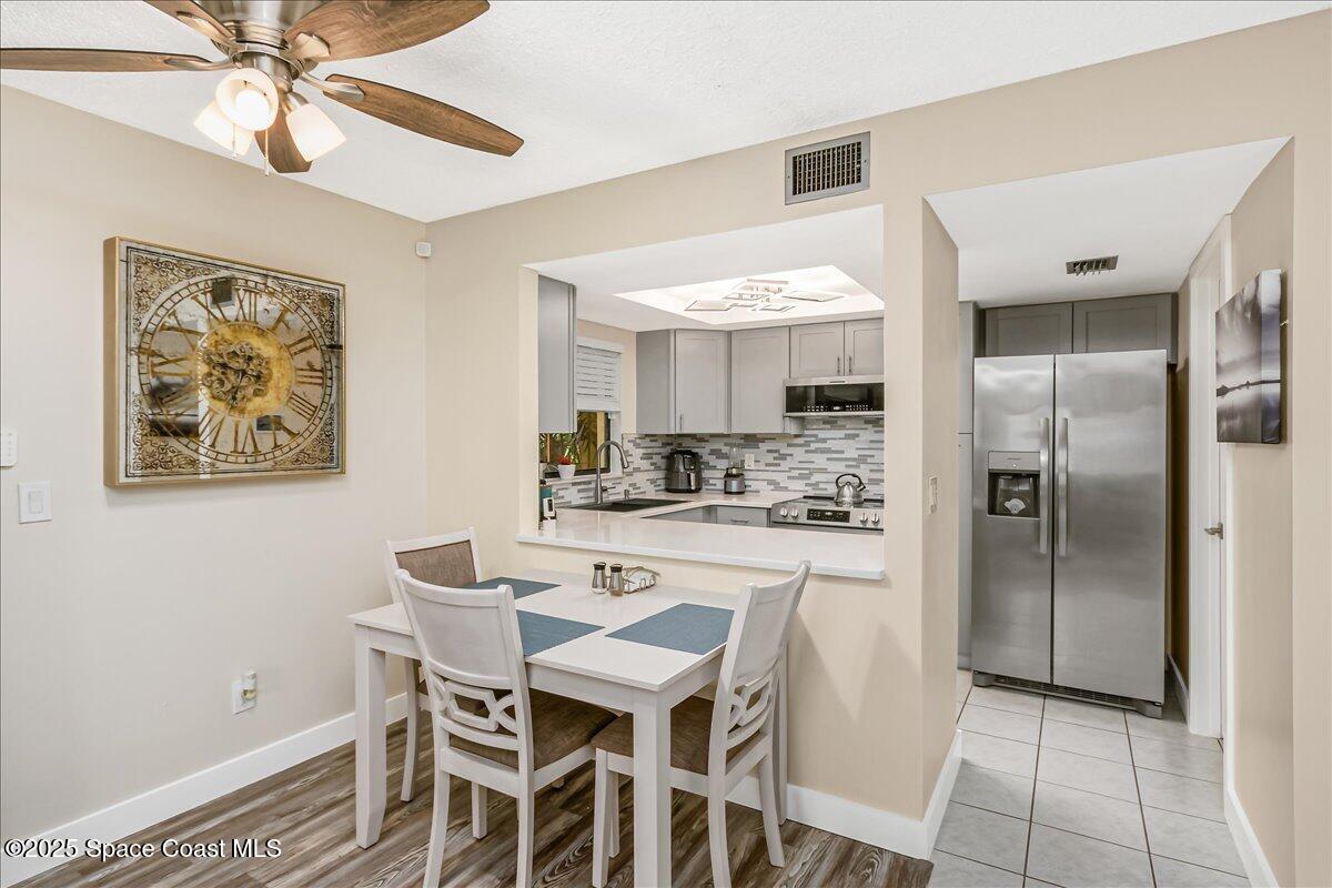 586 North Wickham Road, Unit 63 Melbourne, FL 32935 - Photo 12 of 83 a kitchen with a table and chairs