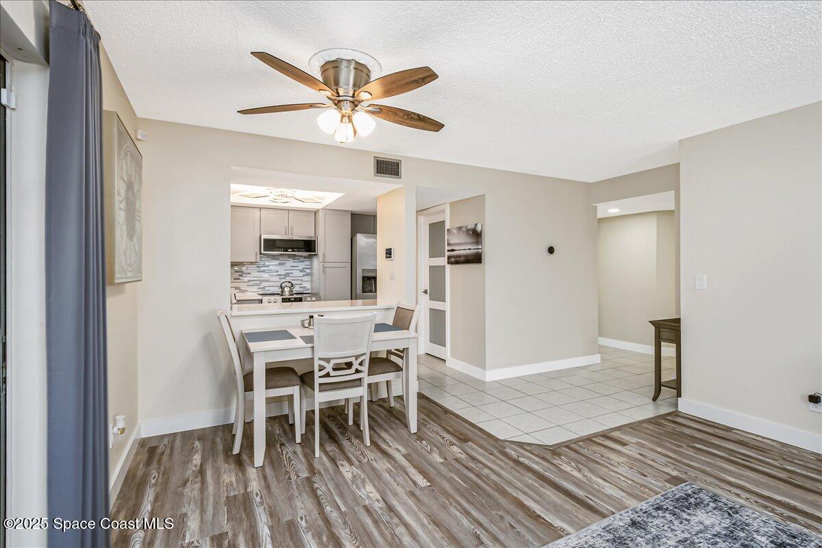 586 North Wickham Road, Unit 63 Melbourne, FL 32935 - Photo 18 of 83 a dining room with a wooden table and chairs