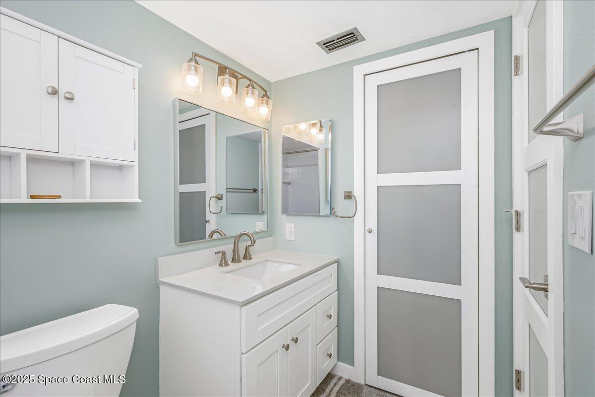 586 North Wickham Road, Unit 63 Melbourne, FL 32935 - Photo 25 of 83 a bathroom with a sink toilet and shower