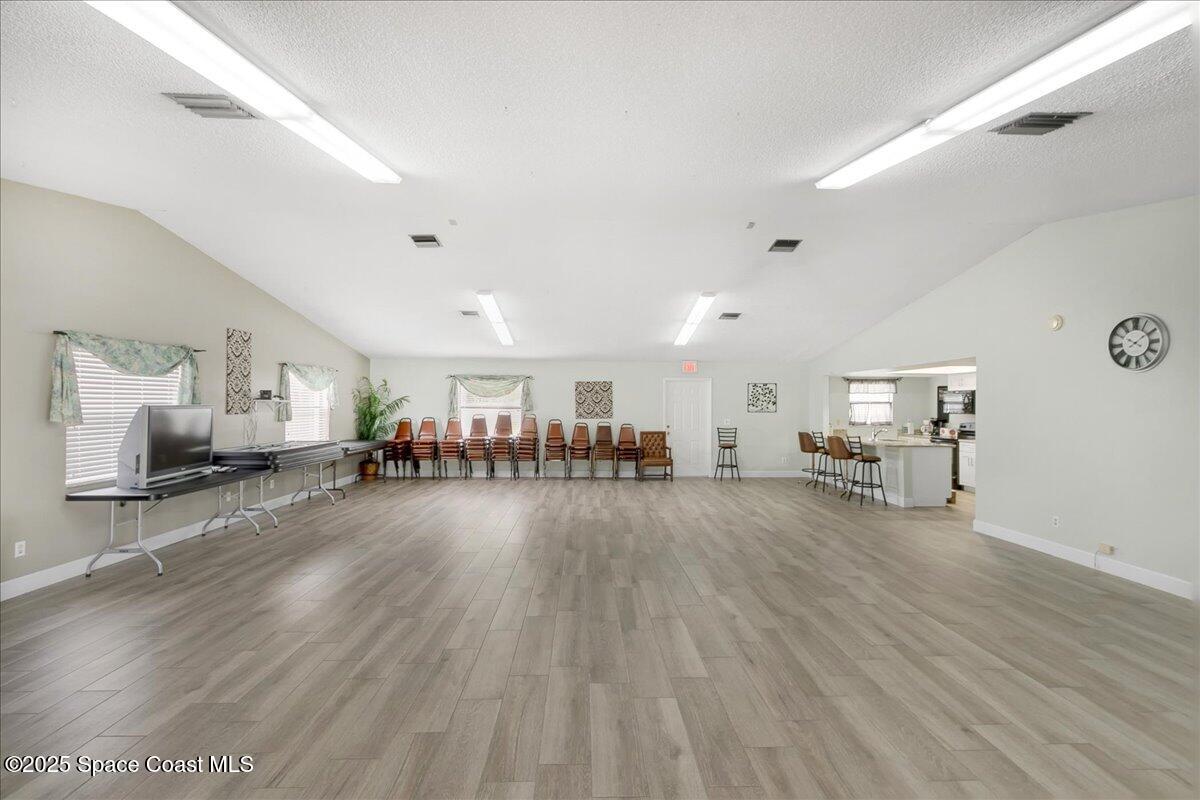 586 North Wickham Road, Unit 63 Melbourne, FL 32935 - Photo 46 of 83 a living room with furniture and a wooden floor