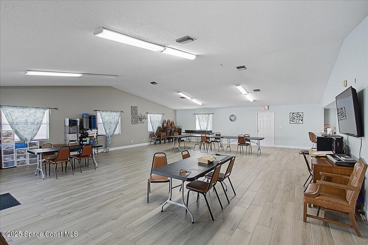 586 North Wickham Road, Unit 63 Melbourne, FL 32935 - Photo 51 of 83 a view of a dining room with furniture and wooden floor