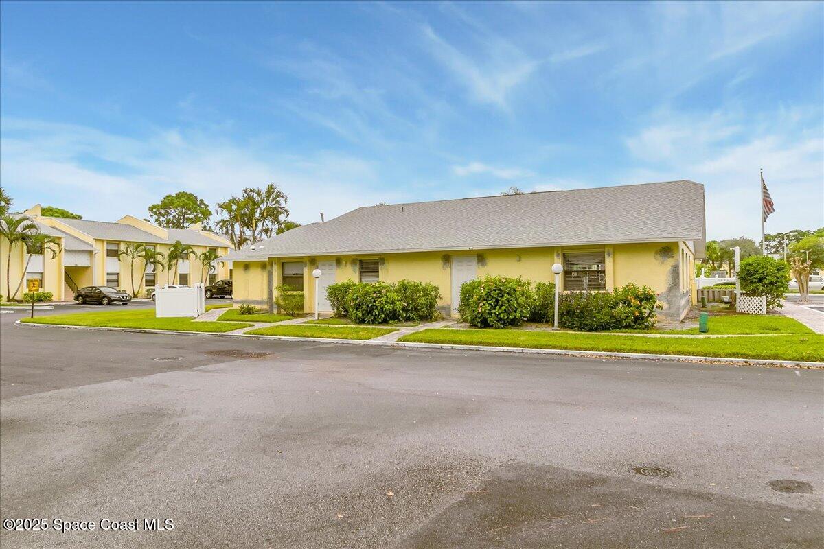 586 North Wickham Road, Unit 63 Melbourne, FL 32935 - Photo 56 of 83 a view of a house with a yard and plants