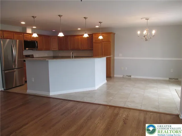 a view of kitchen with refrigerator and window