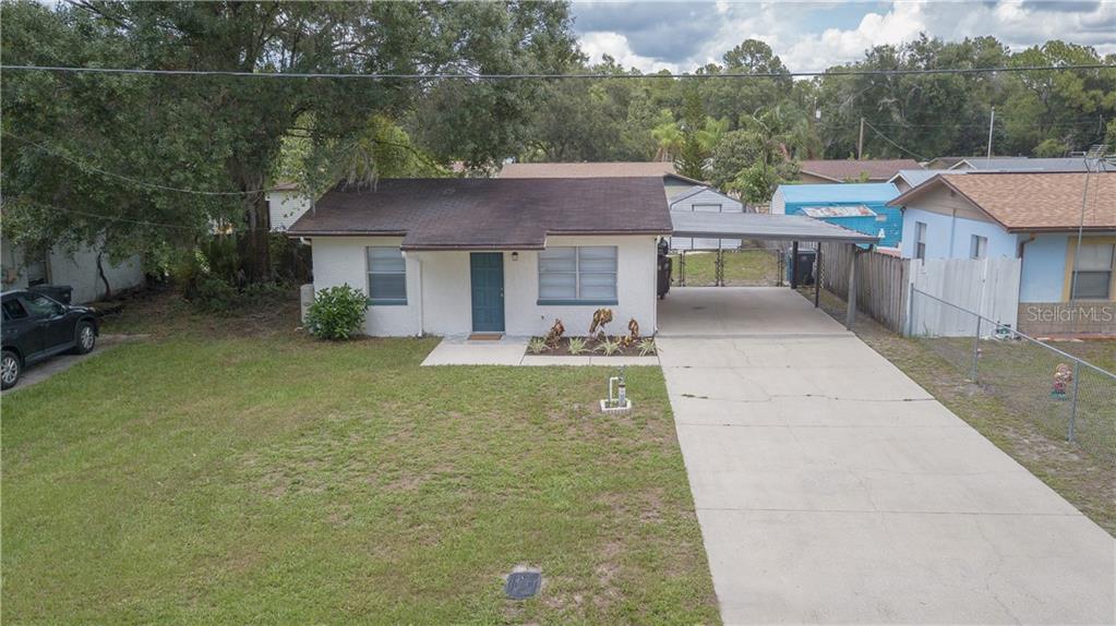 a view of a house with pool and a yard