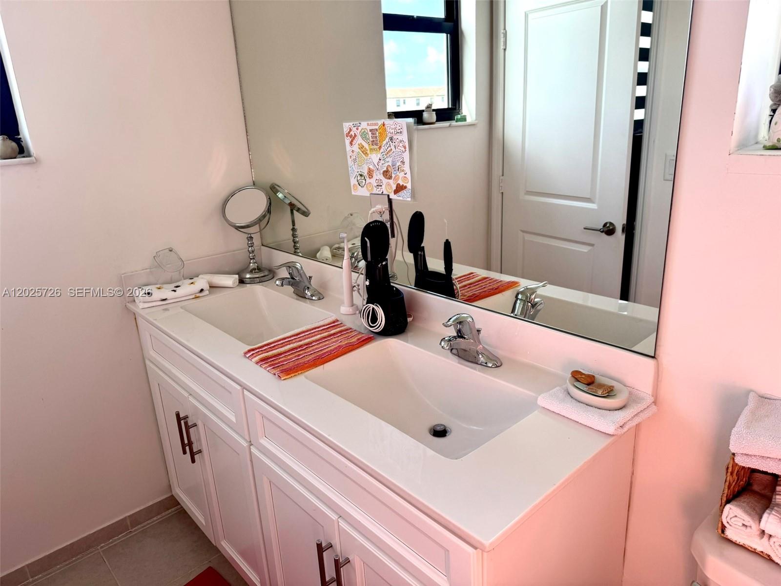 10020 Southwest 228th Terrace Miami, FL 33190 - Photo 13 of 22 a bathroom with a sink and a mirror