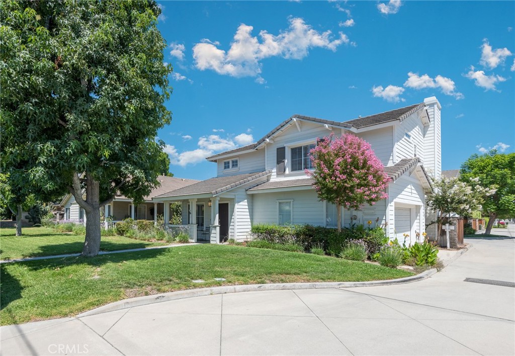 a front view of a house with a yard and a garage