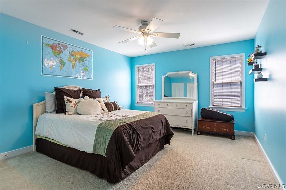 14006 Planters Walk Drive Midlothian, VA 23113 - Photo 31 of 48 a bedroom with a bed a couch and a chandelier