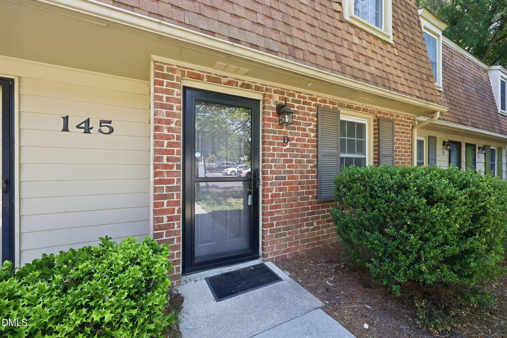 145 Jones Franklin Road, Unit D Raleigh, NC 27606 - Photo 2 of 23 a view of a brick house with a large windows